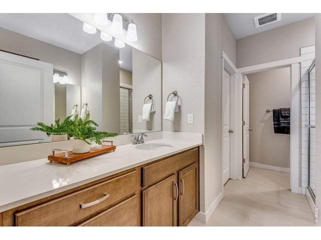 Property Photo 10 Loaded with vanity space in this stunning primary bathroom! Tile floors & Walk-in closet! Dual Vanities.