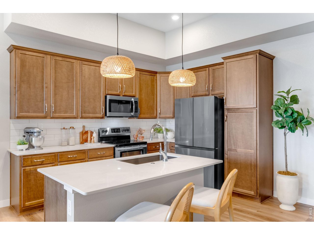 Pretty Quartz Countertops and Maple cabinetry and full tile backsplash