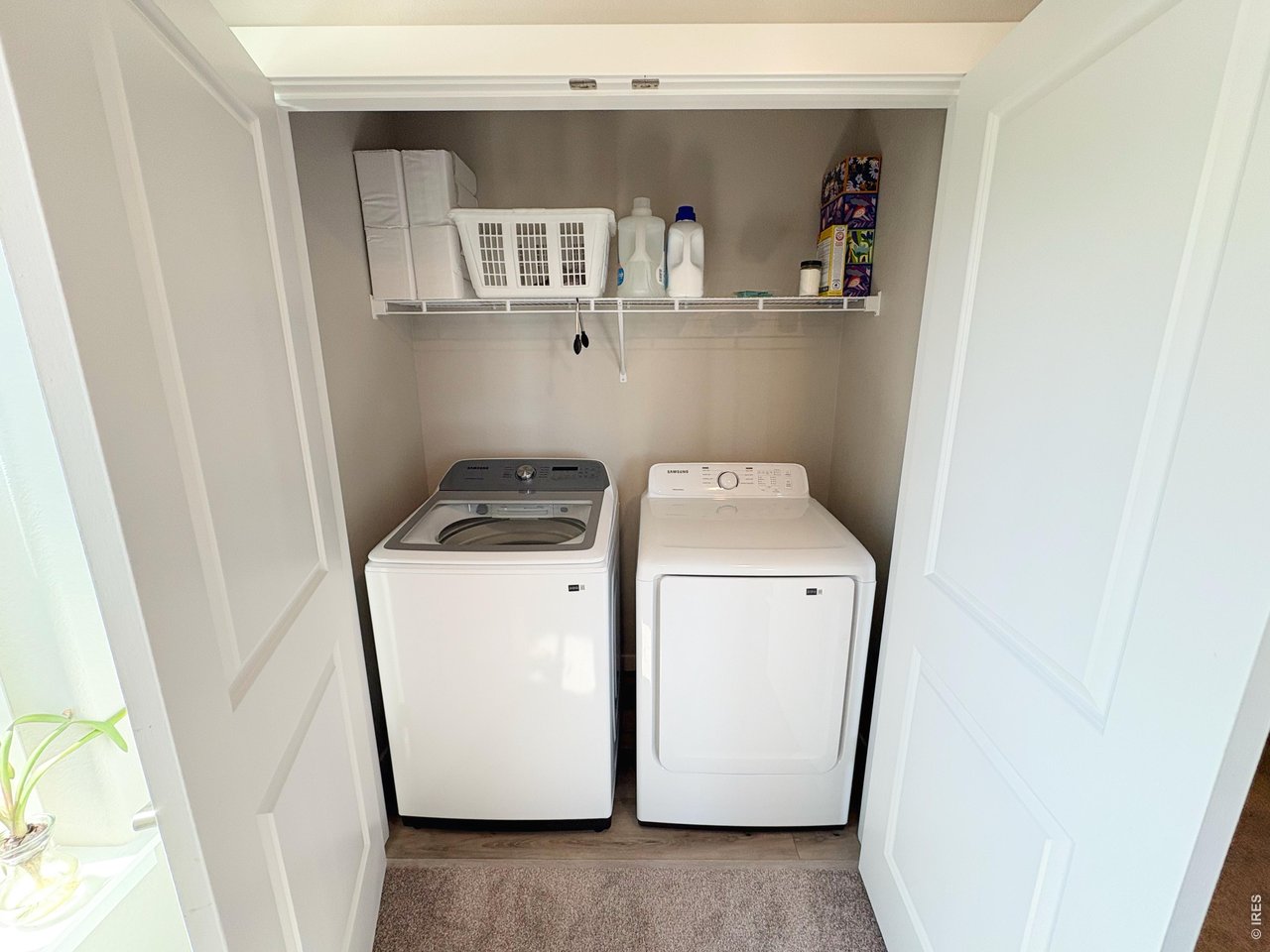 Laundry room upstairs adjacent to master bath.