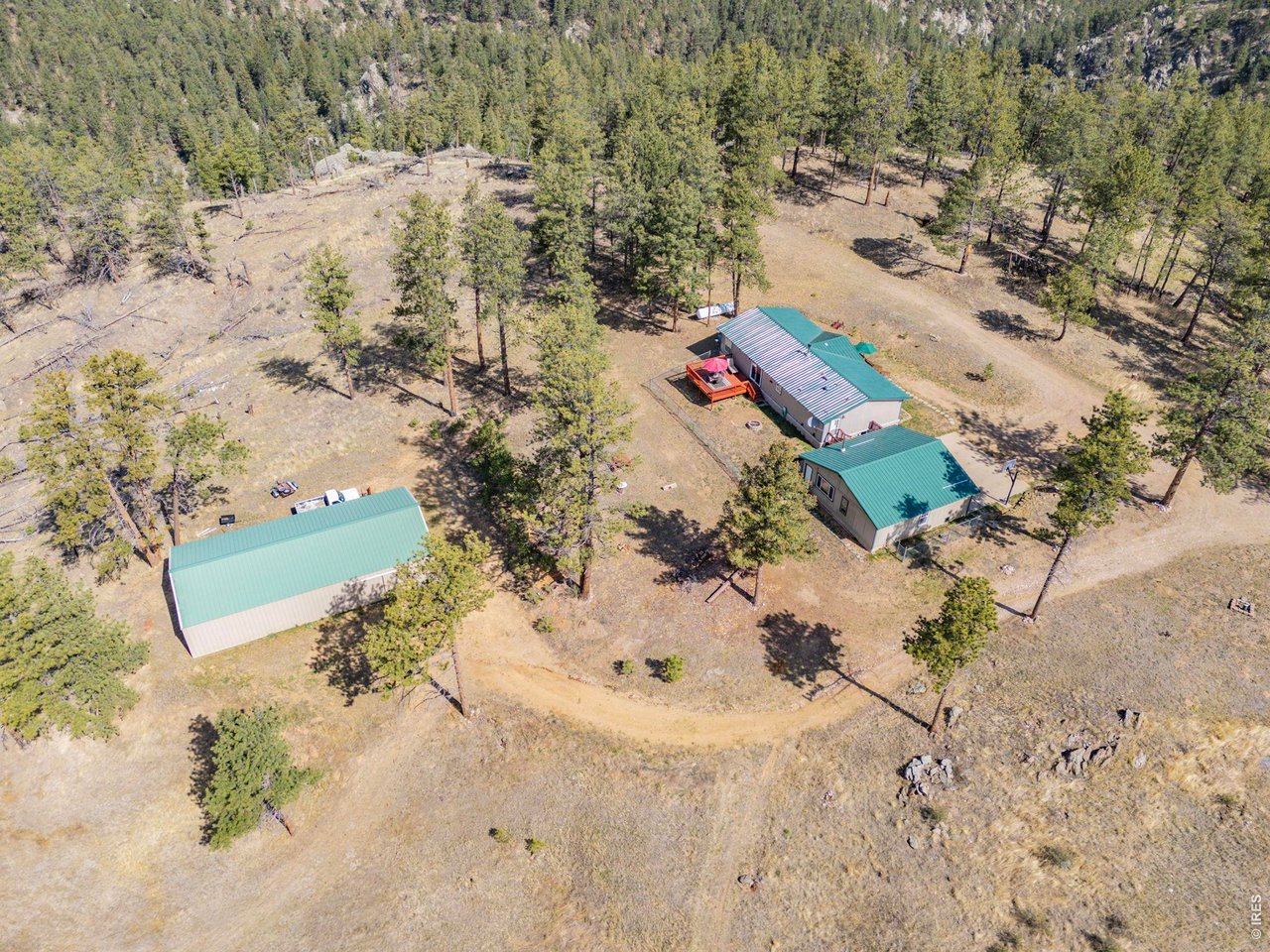 This mountain home on 35 acres is complete with oversized 900 sq ft 2 car garage and 1,800 sq ft shop/outbuilding!