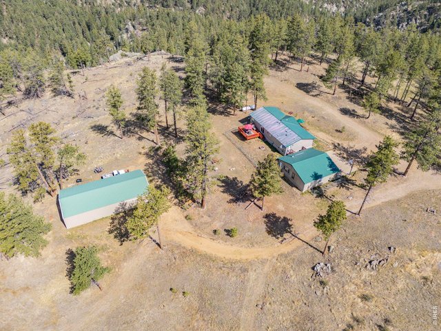 Property Photo 2 This mountain home on 35 acres is complete with oversized 900 sq ft 2 car garage and 1,800 sq ft shop/outbuilding!