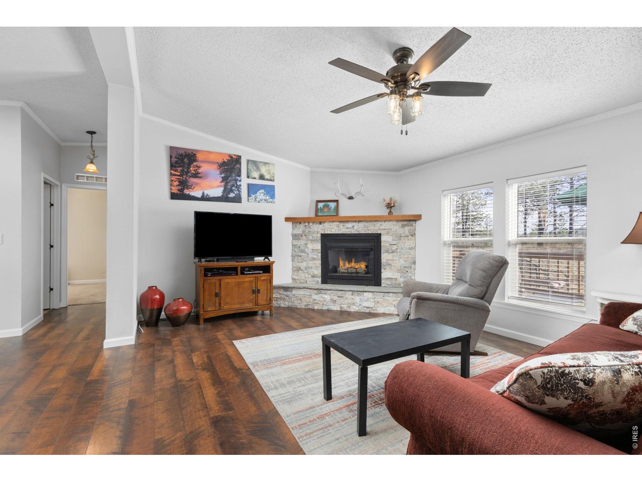 Updated lighting and beautiful propane/gas fireplace with new mantle and stone surround.