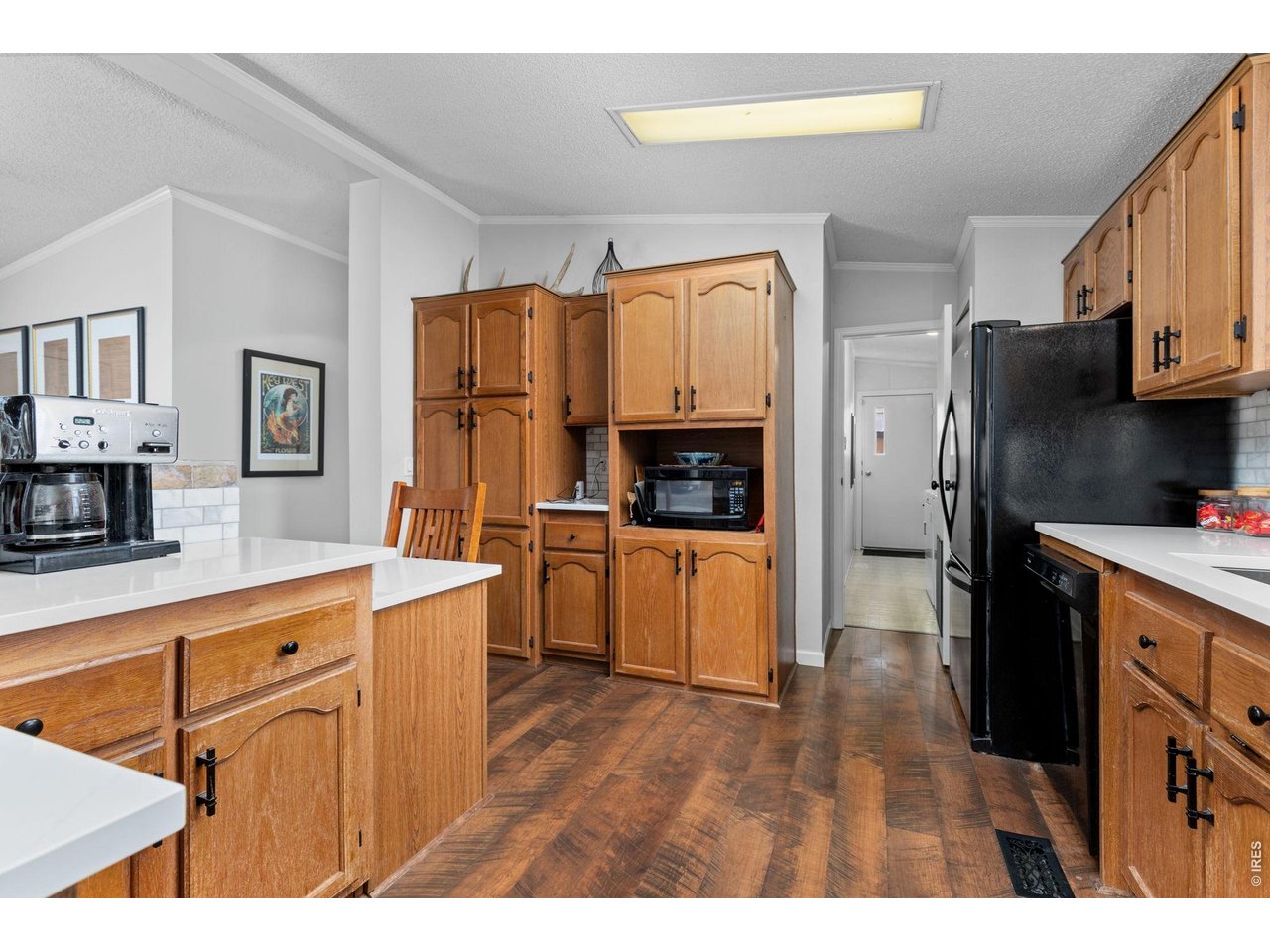 Kitchen has upgraded quartz countertops and marble tile backsplash. 