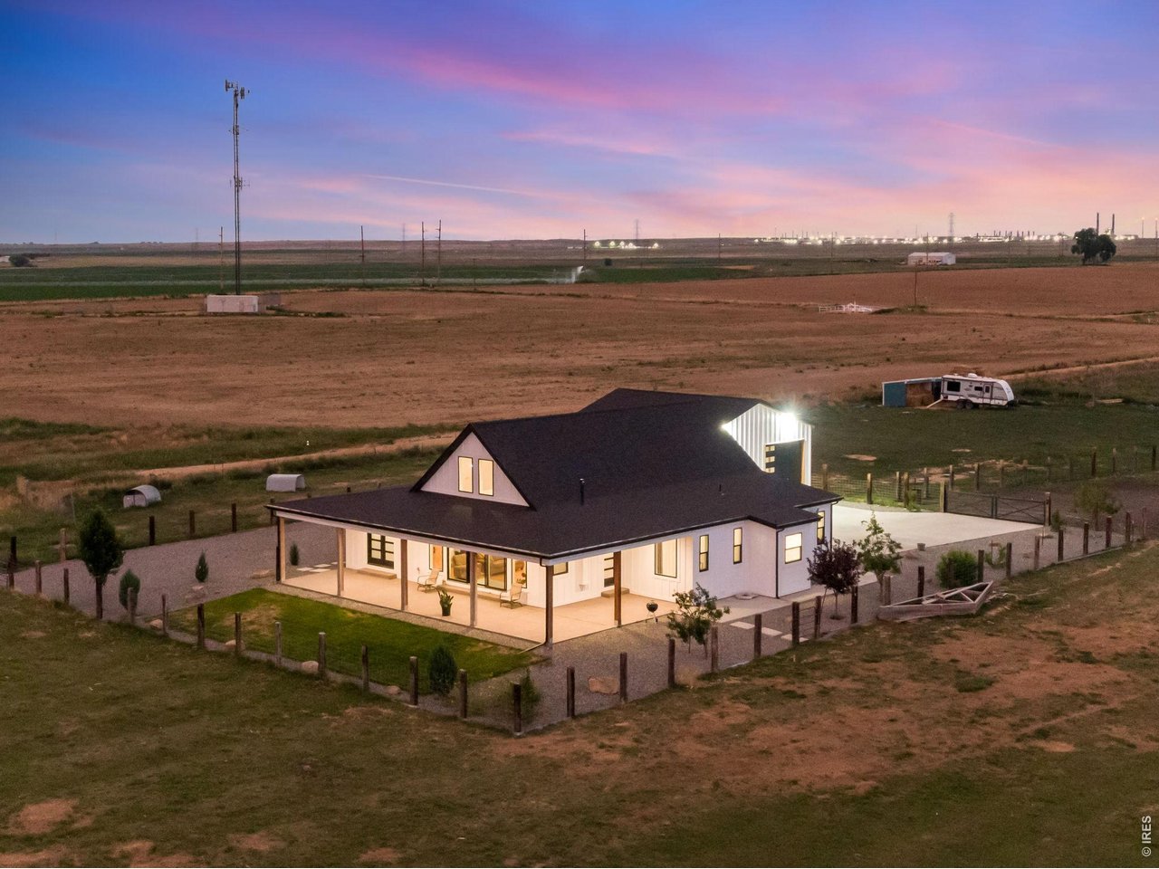 The exterior welcomes you with custom railroad tie and hog wire fencing,