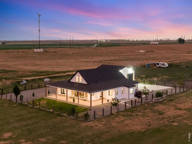 Property Photo 2 The exterior welcomes you with custom railroad tie and hog wire fencing,