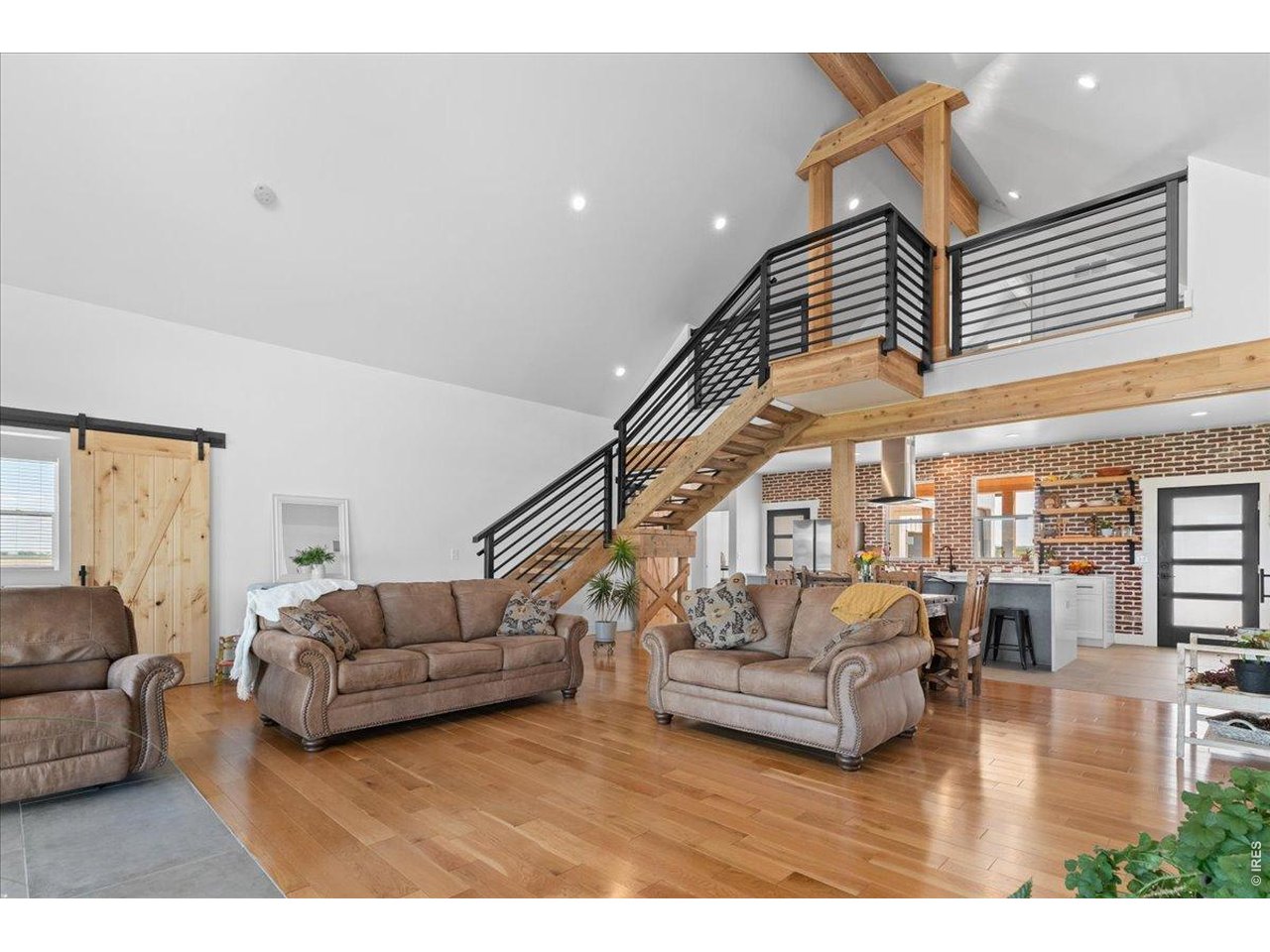 Spacious family room is open, bright and features incredible views, vaulted ceilings, a cozy and energy efficient King pellet stove