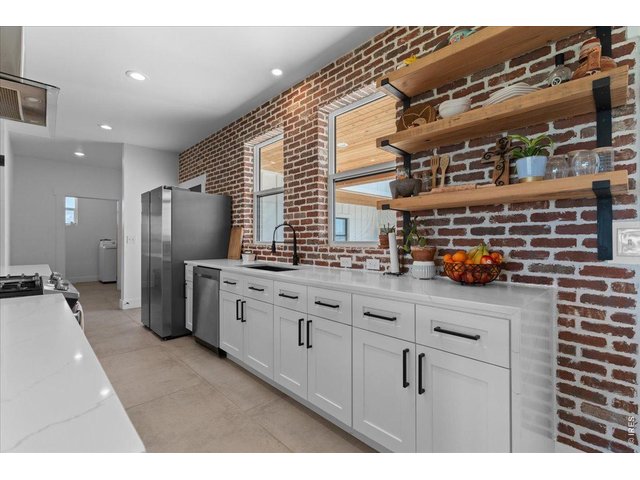 Property Photo 14 Open kitchen designed for functionality and or to entertain features quartz countertops