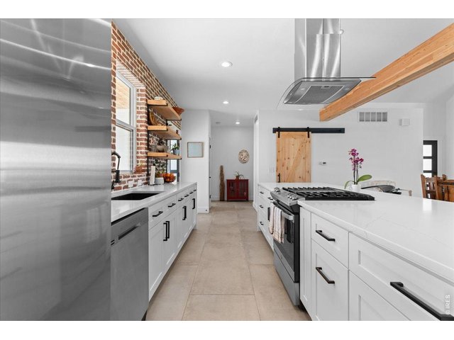 Property Photo 15 Center island with breakfast bar and water fall edge, 2 pantries with barn doors