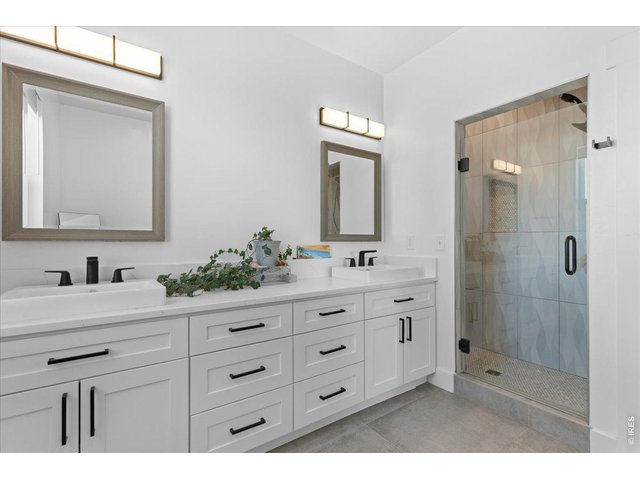 Property Photo 29 luxury bath with tile flooring, quartz countertop, shower with overhead and wand