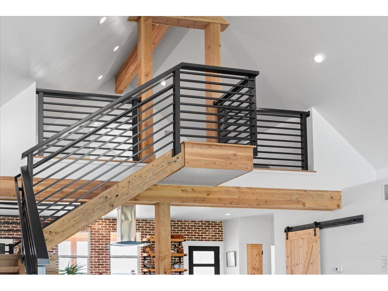 Grand central staircase with custom iron railing and wood steps
