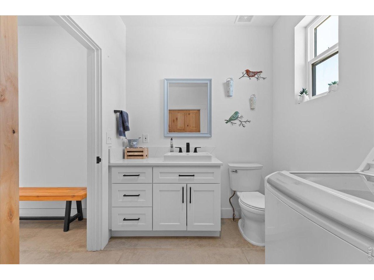 Jack and Jill full bath features 2 vessel sinks, quartz countertop, tile flooring, and decorative tile backsplash