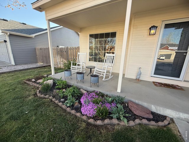 Property Photo 3 Exterior Front Patio and Garden Bed