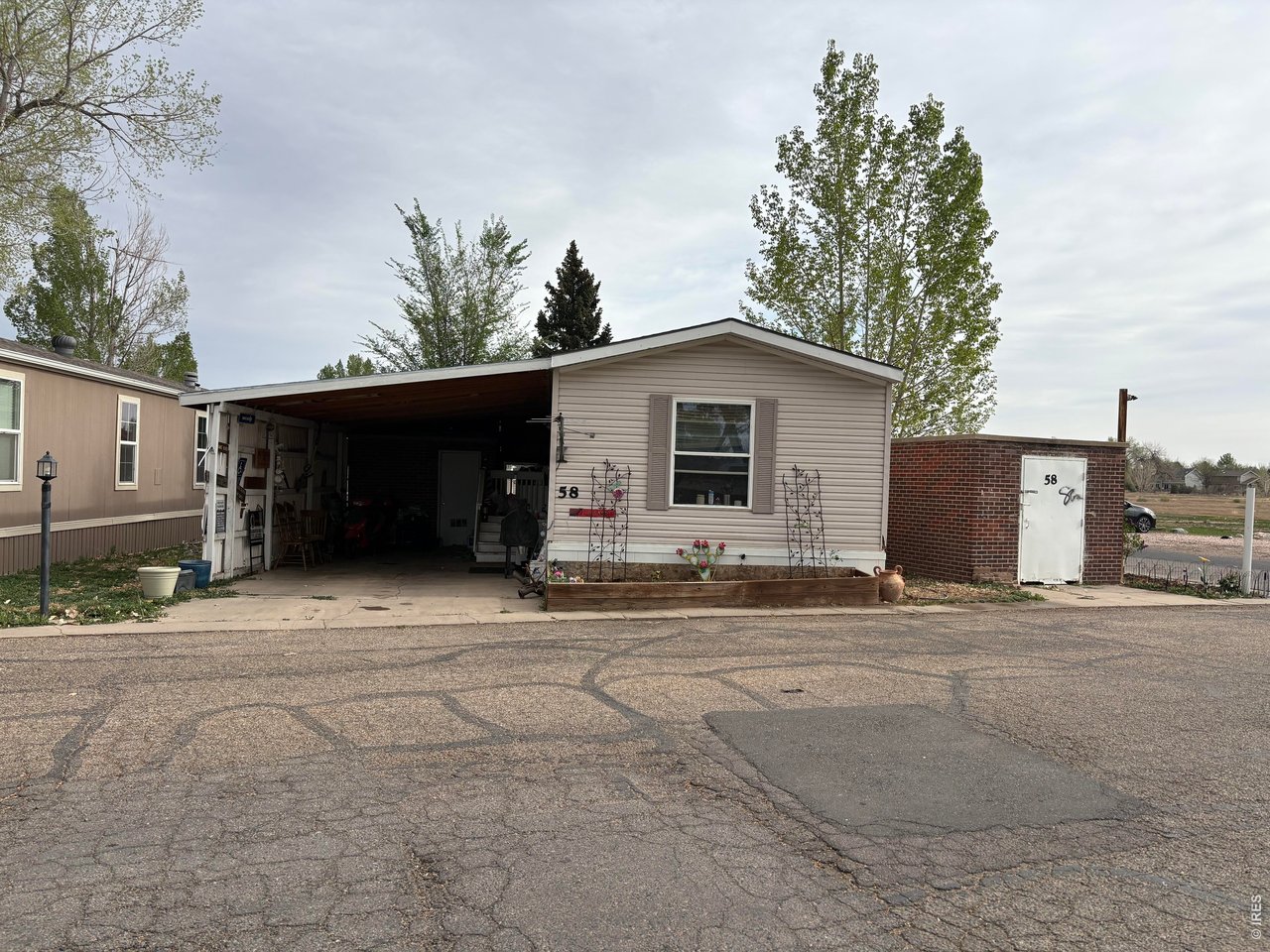 Corner lot, 2 bed 2 Bath home with 3 storage buildings in Cloverleaf Community.