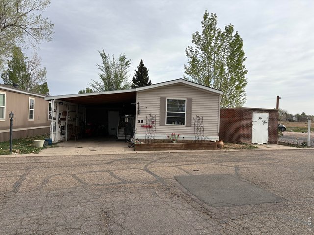 Property Photo 2 Corner lot, 2 bed 2 Bath home with 3 storage buildings in Cloverleaf Community.