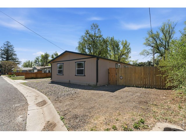 Property Photo 36 Additional parking on west side of house and access gate to 2 bedroom side.