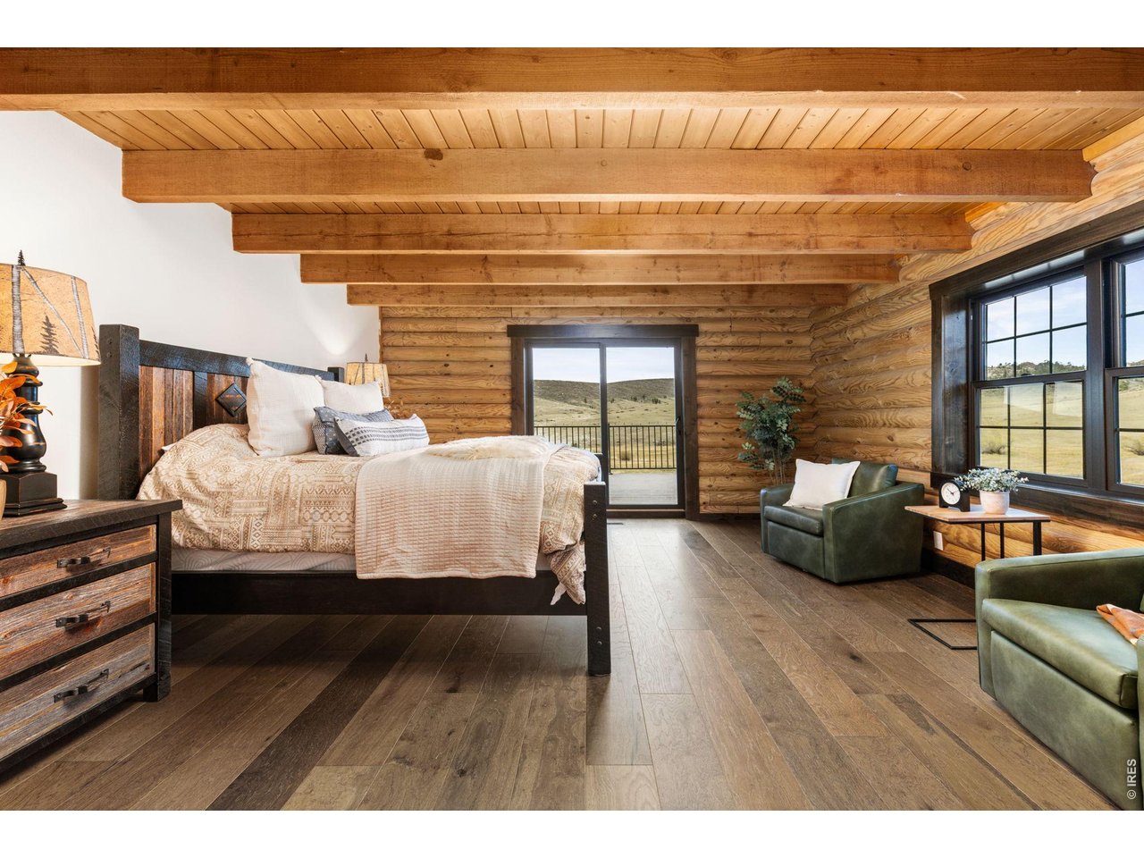 The main floor primary bedroom with slider to the back deck. 