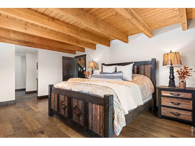 Property Photo 17 Primary Bedroom with attractive wood beams. 
