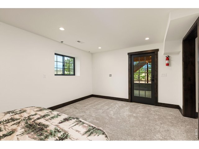 Property Photo 30 Home Office currently being used as a Spare/Guest Bedroom with door to patio.