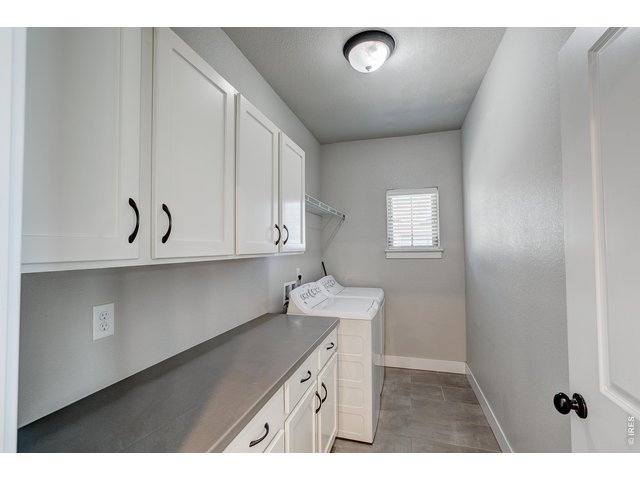 Property Photo 18 Laundry room off the kitchen with built-in cabinets. Washer/dryer included.