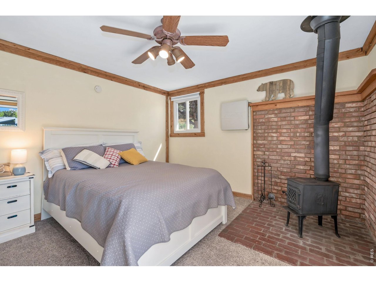 Non-conforming primary bedroom includes a cozy free-standing wood fireplace 