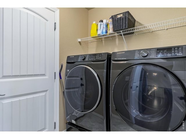 Property Photo 15 Laundry Room is situated off the garage and kitchen