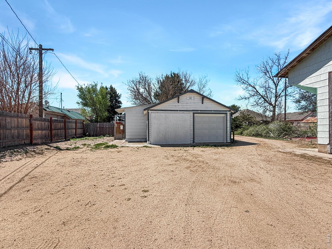 Alley view of garage, new door on the right