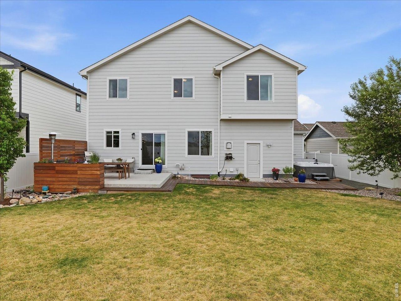 Rear Of Two Story Home With Patio