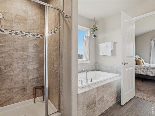 Property Photo 21 Soaking Tub and Tiled Shower in Primary En Suite