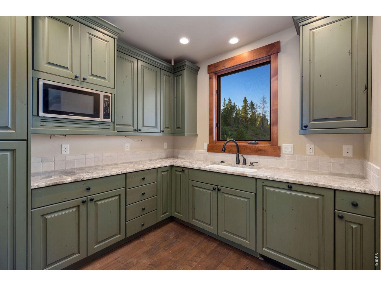  Second prep kitchen with additional custom cabinetry, dishwasher, sink and microwave 