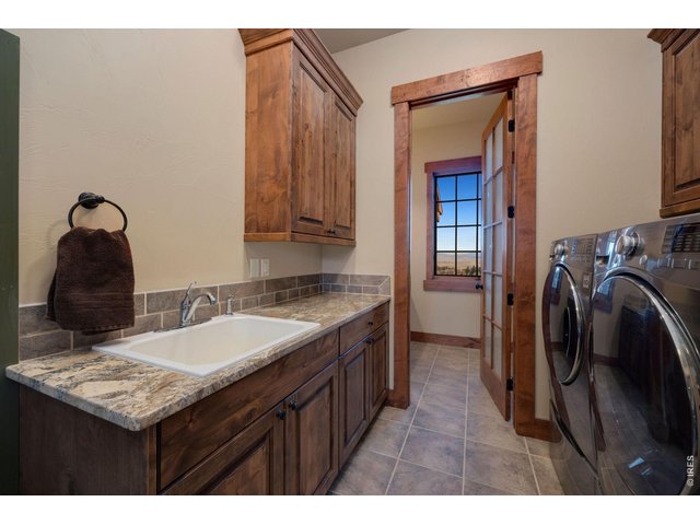Property Photo 20 Main floor mud room with sink, washer/dryer additionally adjoining bathroom with sink and shower
