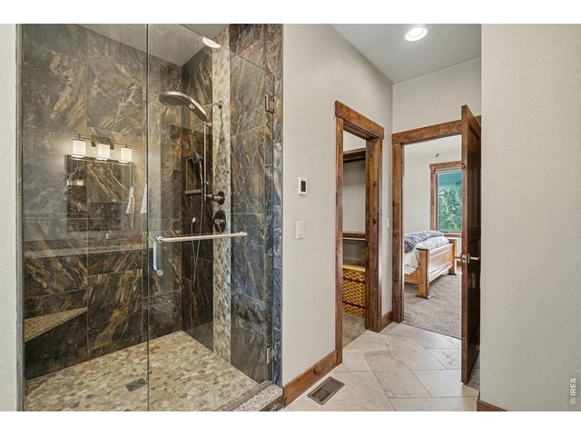 Property Photo 21 Primary bath with oversized walk in shower, walk in closet