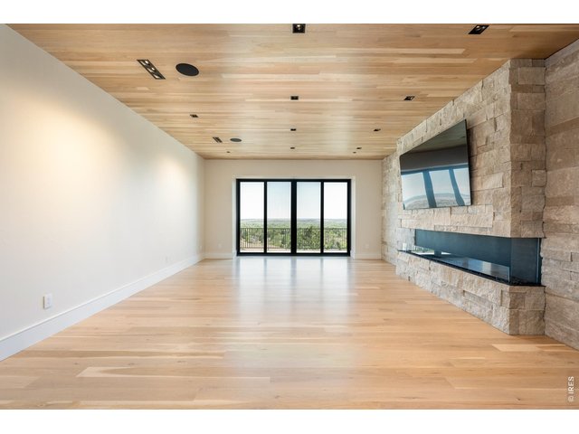 Property Photo 37 Main level family room with oversized sliding glass doors and contemporary EcoSmart Flex Series gas fireplace