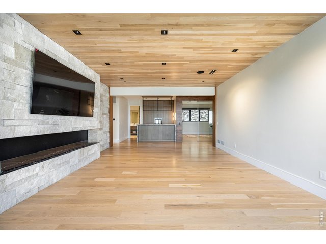 Property Photo 38 Stay cozy in the main level family room with outdoor living access and fireplace, follow the hallway to three guest bedrooms and each equipped with its own en suite bathroom, and outdoor access to porches and patios and the pool. 