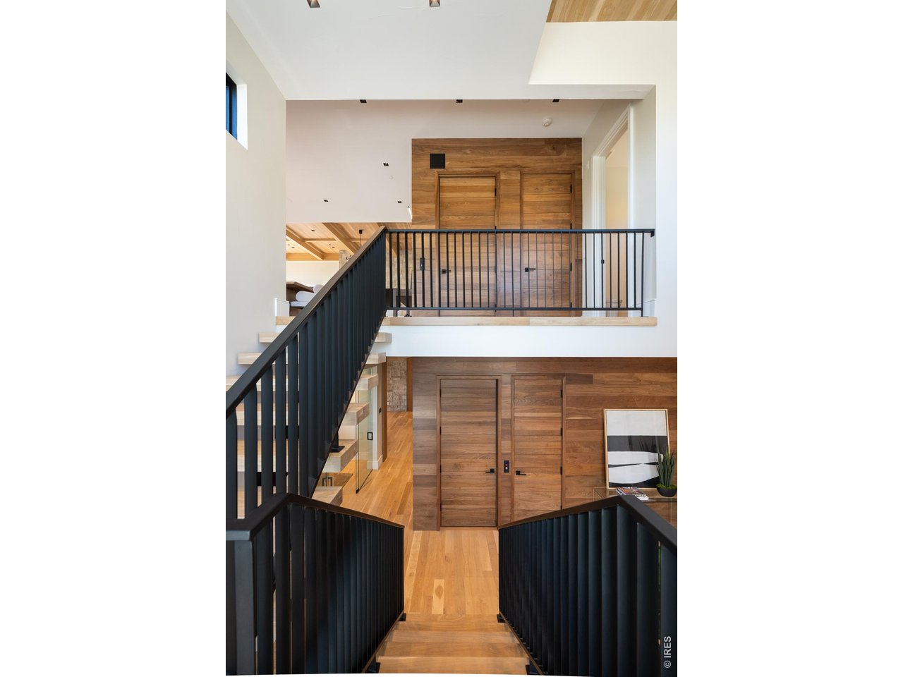 Follow the stairwell to the breathtaking upper level, encompassing a spacious living room, dining room, kitchen, and a versatile primary suite retreat.