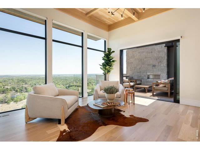 Property Photo 18 A relaxing sitting room/reading space with direct access to a private balcony with outdoor EcoSmart gas fireplace. 