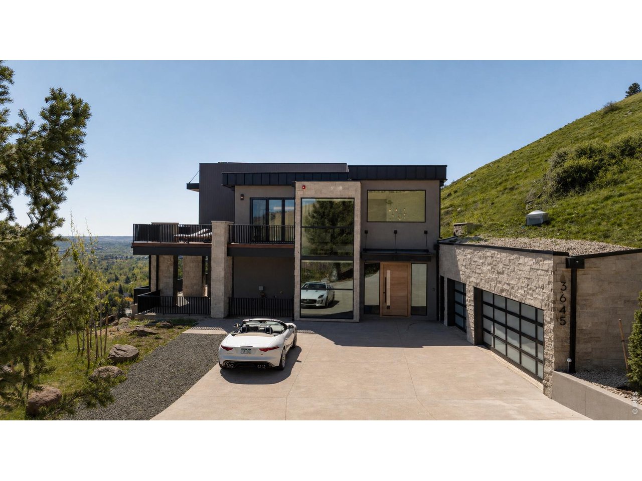 An extraordinary new construction residence overlooking the sweeping beauty of Boulder, this home offers 5,622 SF of impeccably designed living space. *Grass enhanced with AI