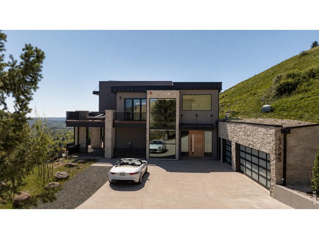 Property Photo 9 An extraordinary new construction residence overlooking the sweeping beauty of Boulder, this home offers 5,622 SF of impeccably designed living space. *Grass enhanced with AI