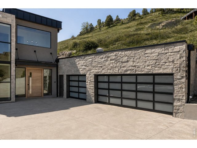 Property Photo 10 A rare offering of a six-car garage, ideal for the discerning car collector. *Grass enhanced with AI