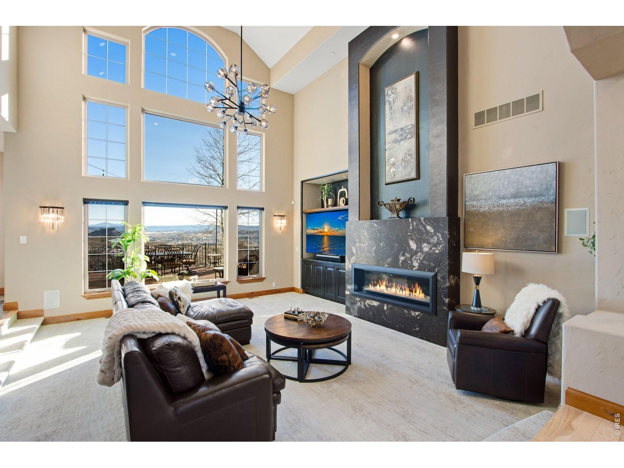 Central great room features 20' ceilings with plenty of can lighting, incredible views of Castle Rock Mountain and Pikes Peak plus a gas fireplace with blower and granite slab backsplash