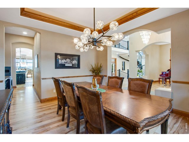 Property Photo 24 Front formal dining room features a tray ceiling, crown molding and rope lighting