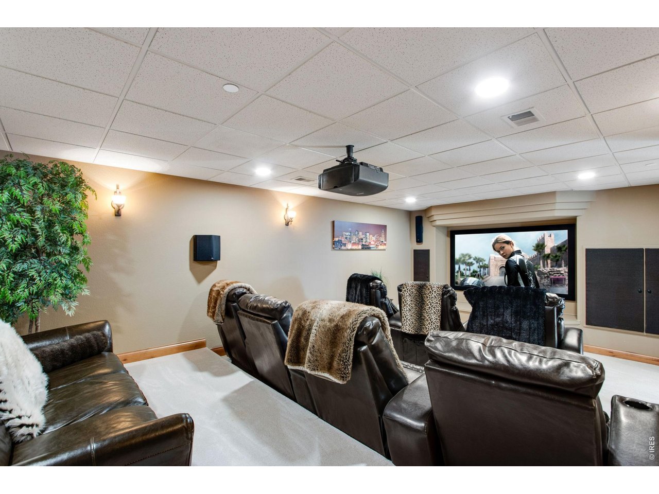 Theater room with stadium seating features a projector, screen, 7 recliners, speakers and all new components included
