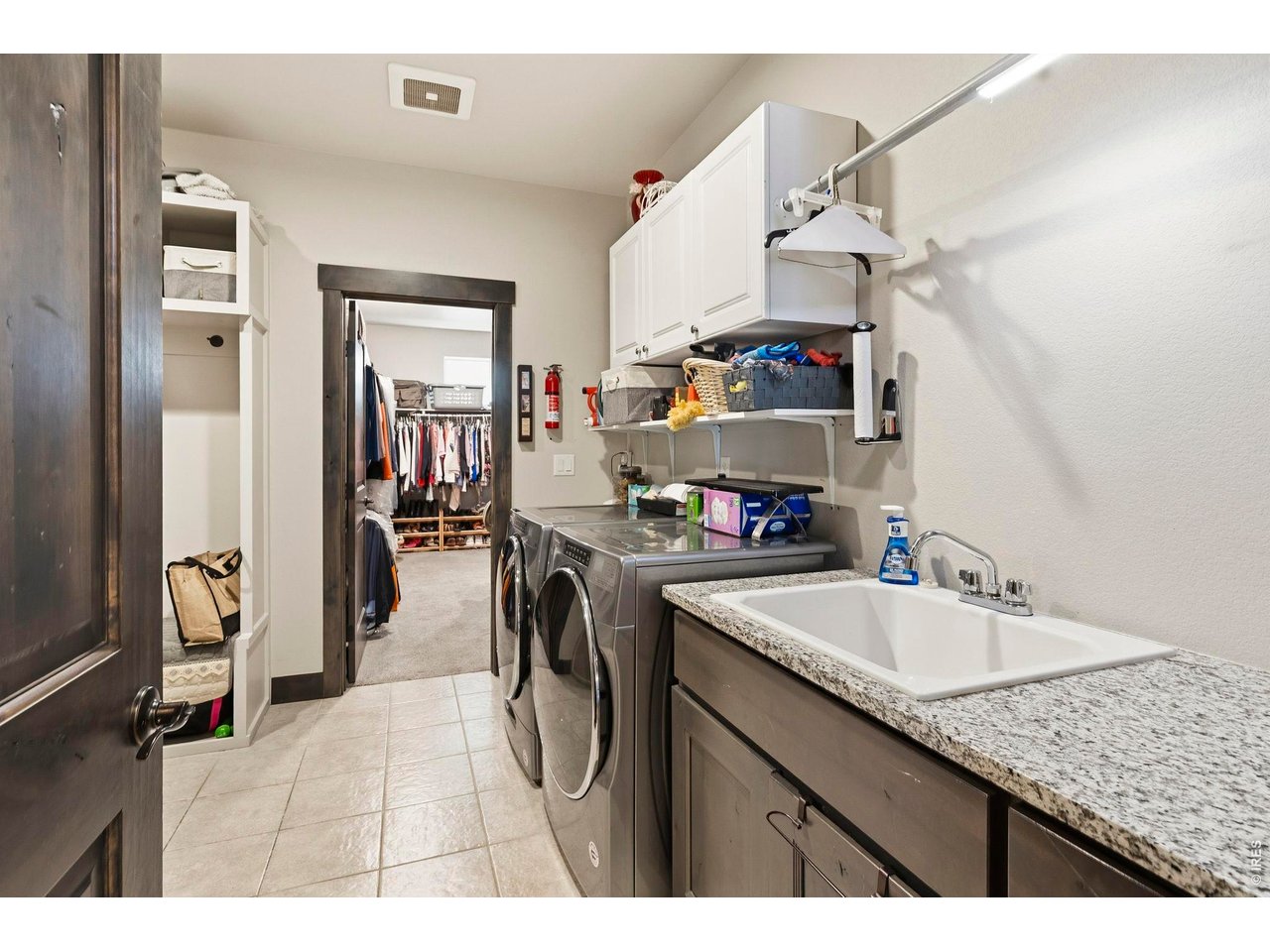 Main level laundry with access to the primary bedroom closet