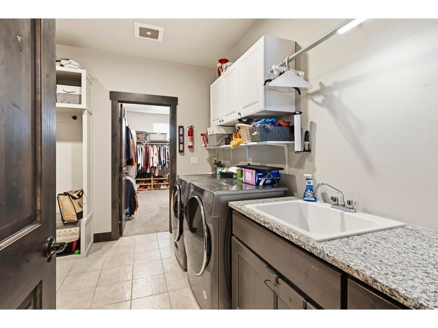 Property Photo 28 Main level laundry with access to the primary bedroom closet