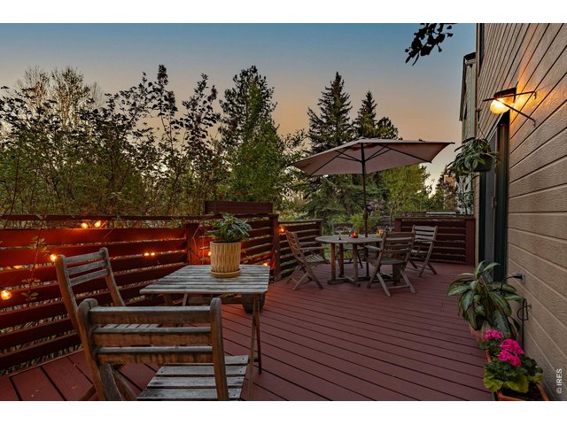 Property Photo 13 The spacious deck offers a perfect space for outdoor dining and summer gatherings. 
