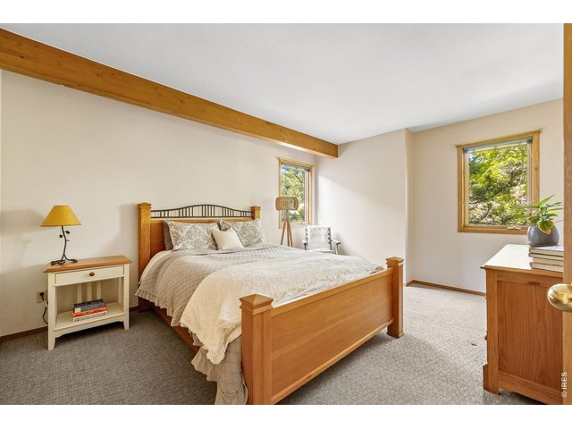 Property Photo 34 Sun-filled bedroom framing leafy nature filled exteriors