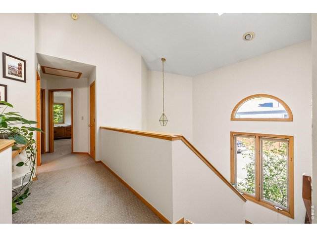 Property Photo 33 The mezzanine hallway leads to two private guest bedrooms