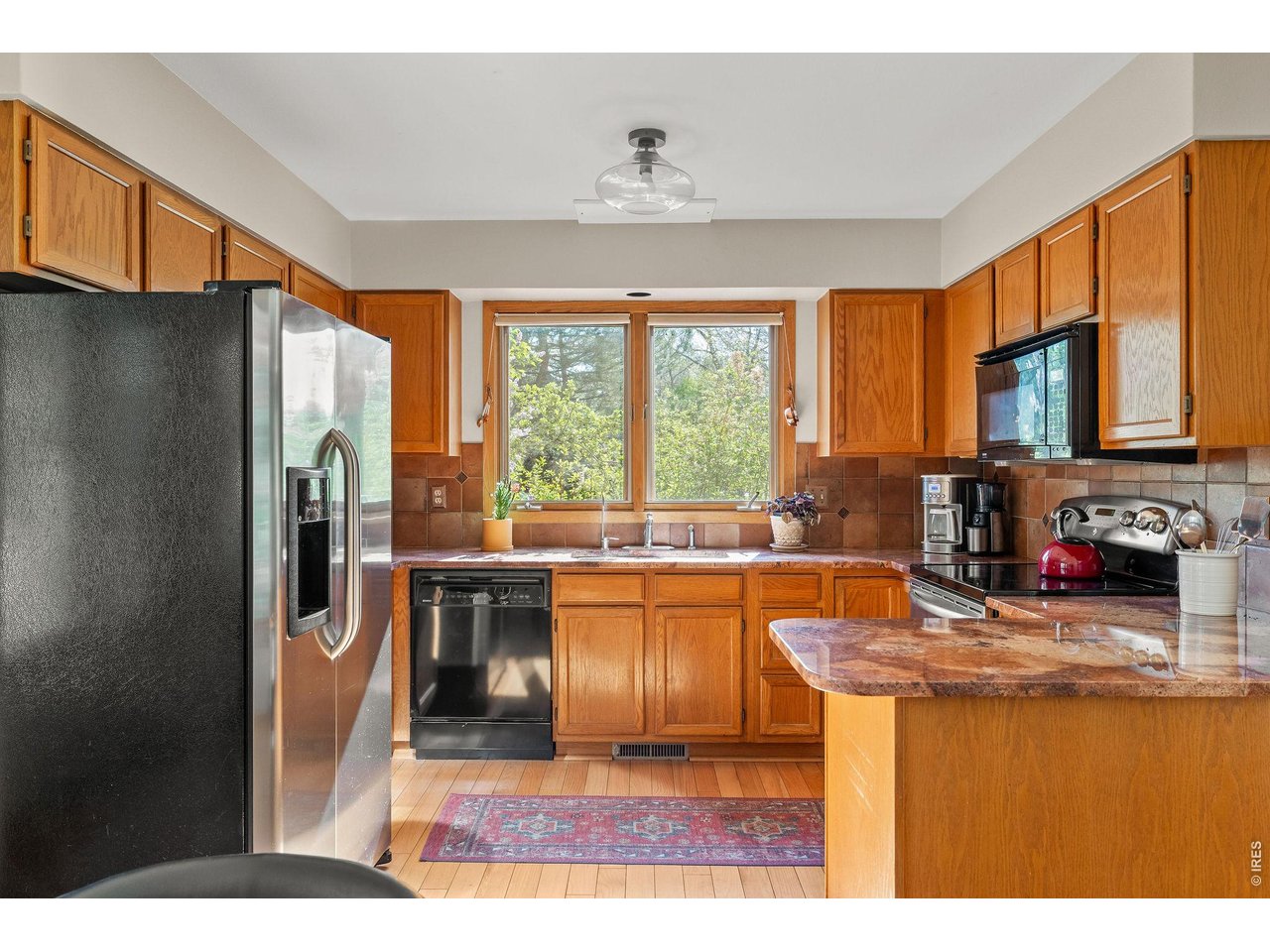 Sun-filled kitchen offers plenty of space for storage, making a tidy, organized kitchen a breeze. 