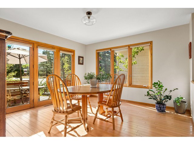 Property Photo 21 Oversized windows frame the dining room space with direct access to the adjacent spacious deck. 