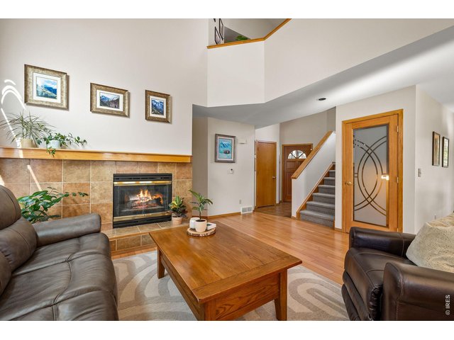Property Photo 23 The living room is framed by soaring ceilings and anchored by an elegant gas fireplace. 