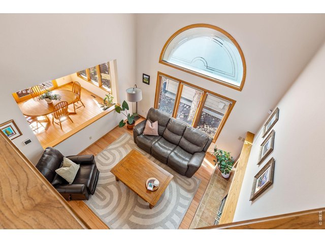 Property Photo 26 The mezzanine hallway overlooks the spacious, sun-filled living room. 